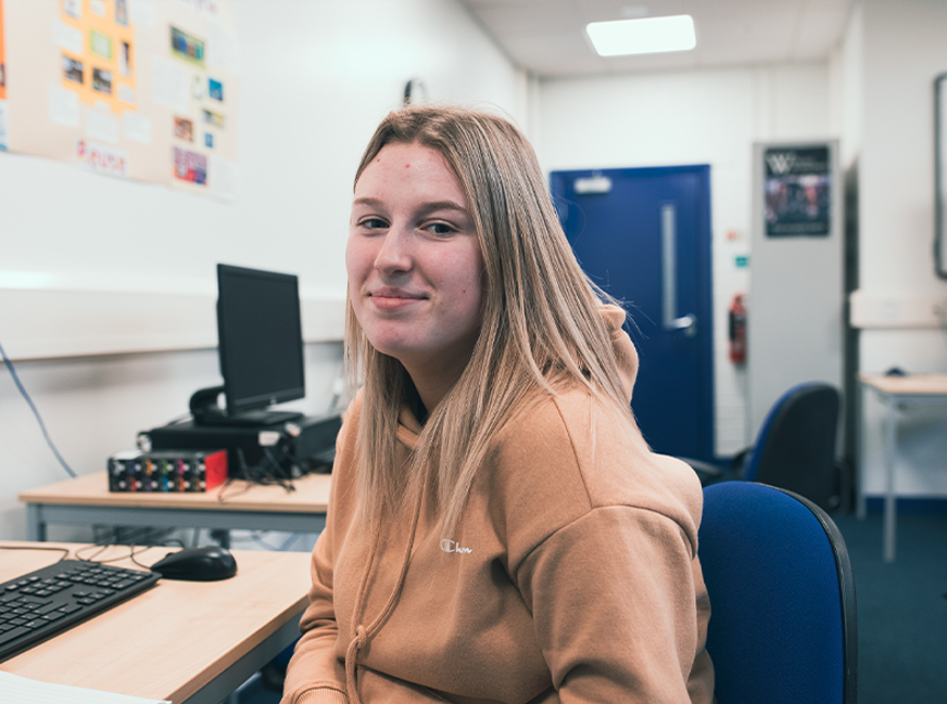 female student looking and smiling at camera