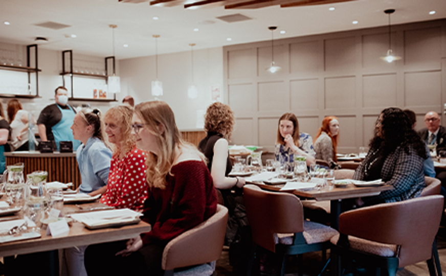 people sitting at tables in fife college training restaurant