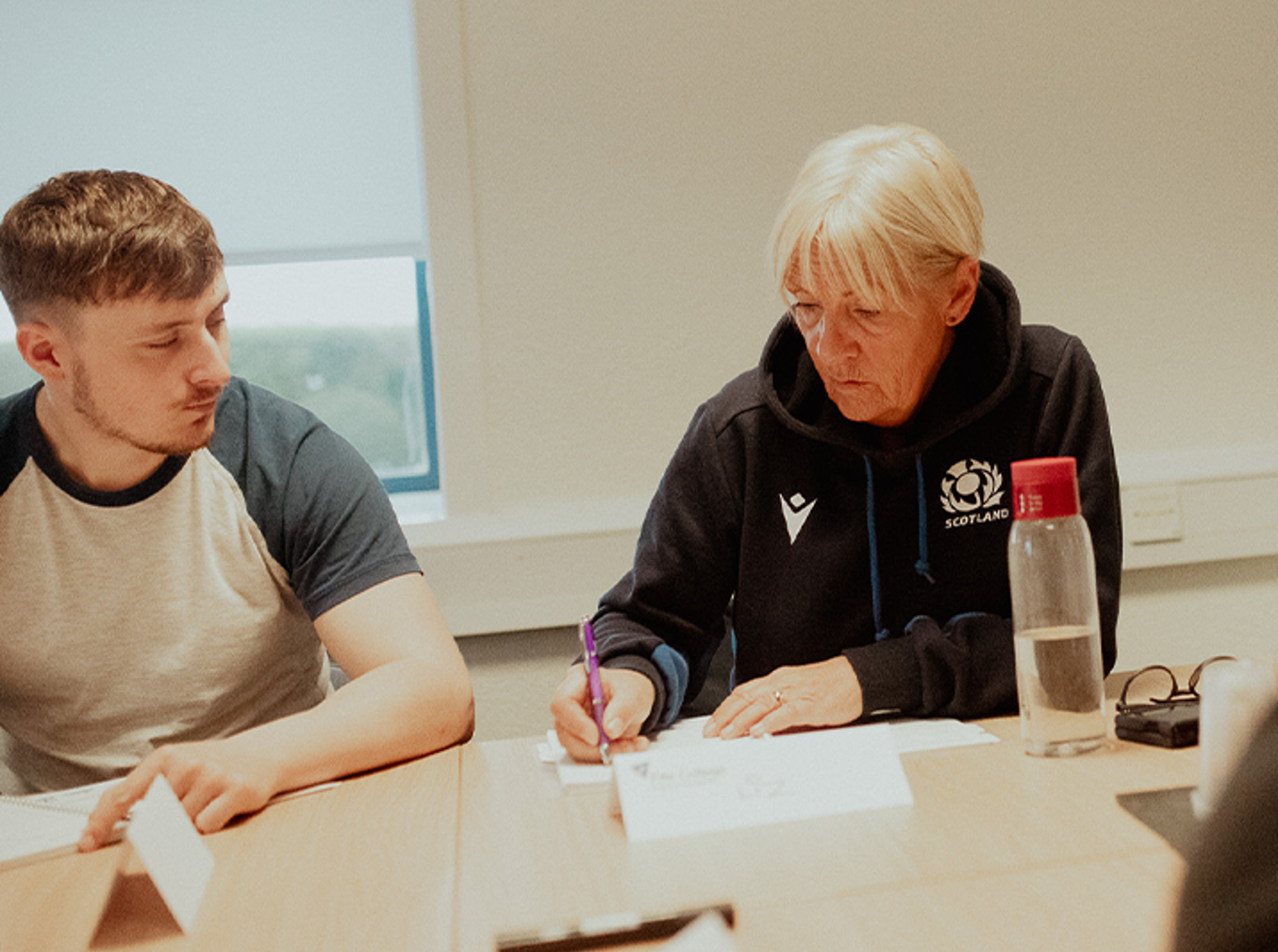 two project management students working at desk