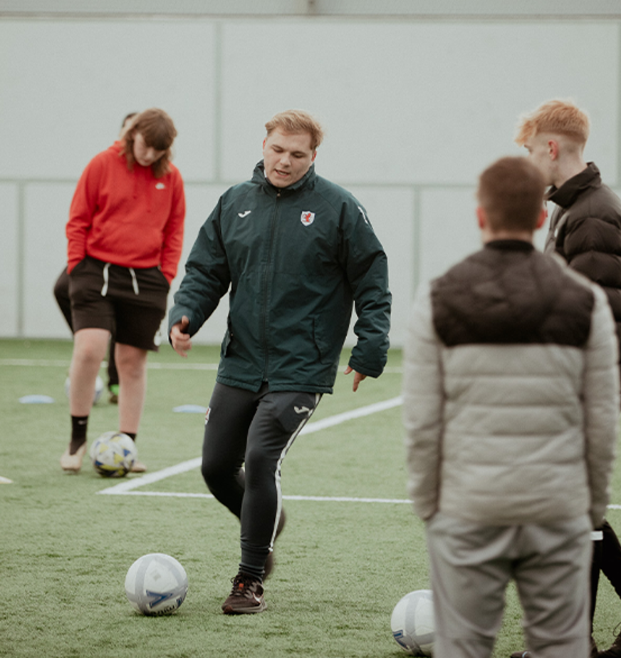 male sports students playing football