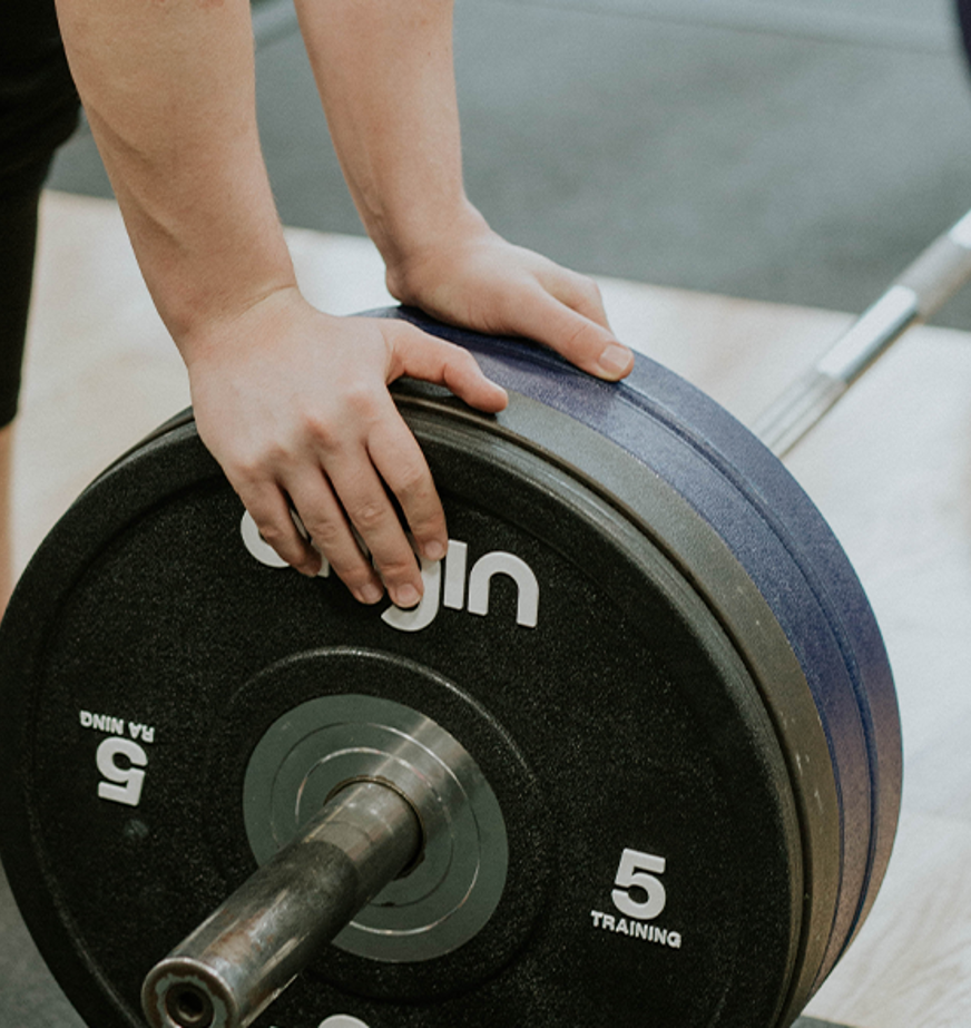 close up of someones hand changing weight on bar close up of someones hand changing weight on bar