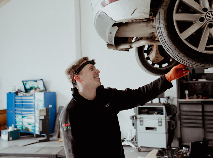 male FA working on wheel on car