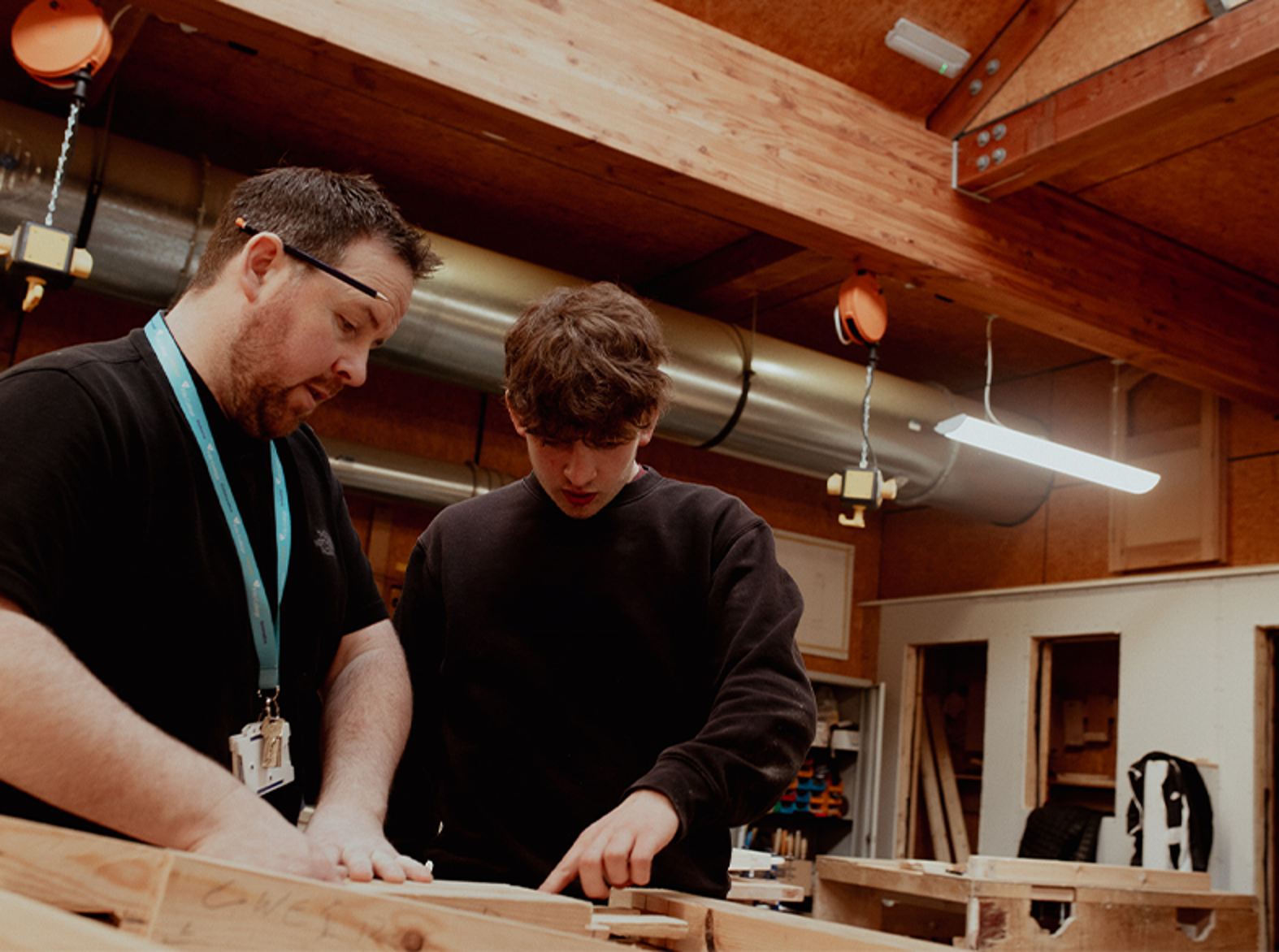 male apprentice student working with lecturer on course work