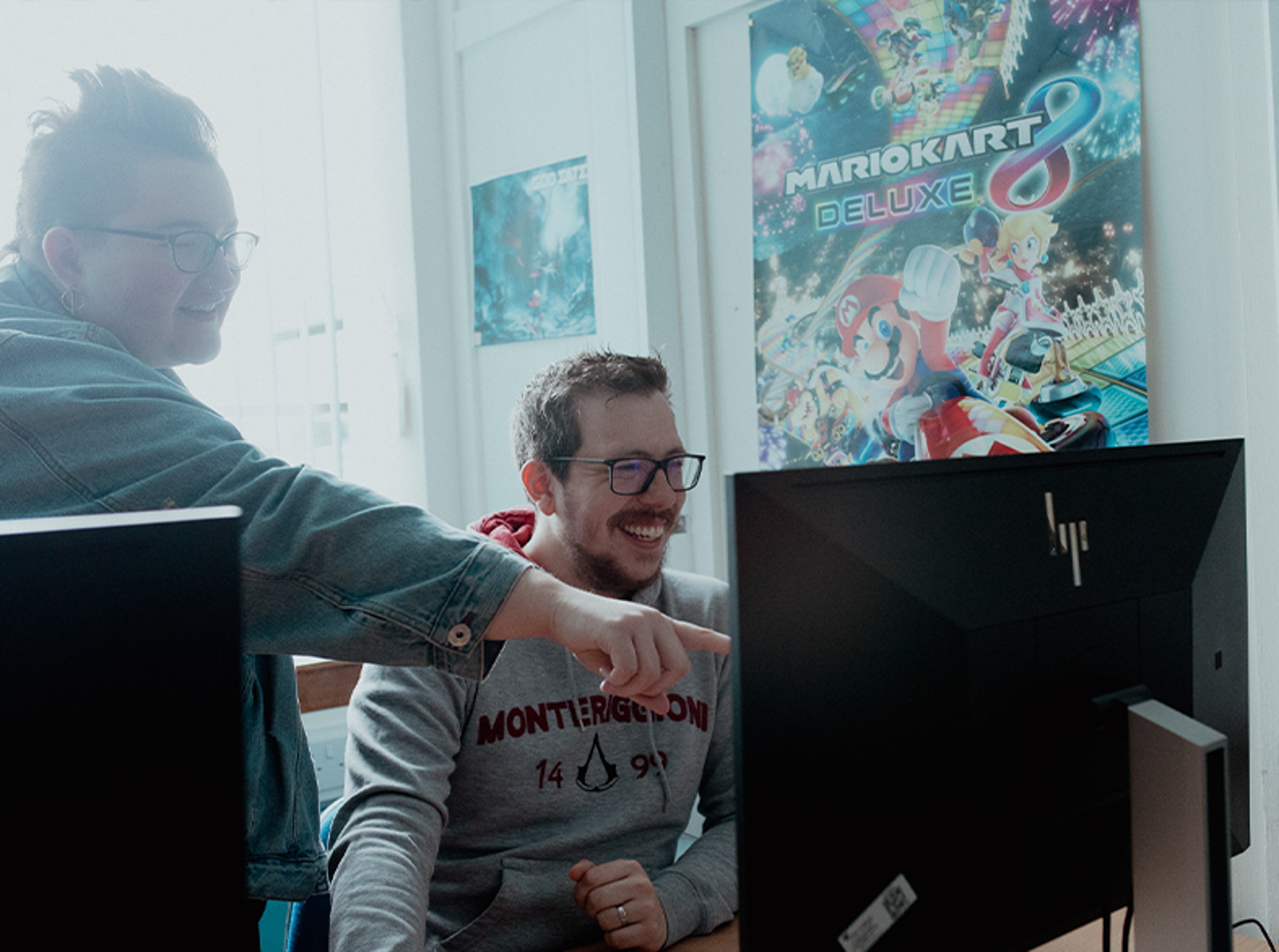 female lecturer showing male student work on computer