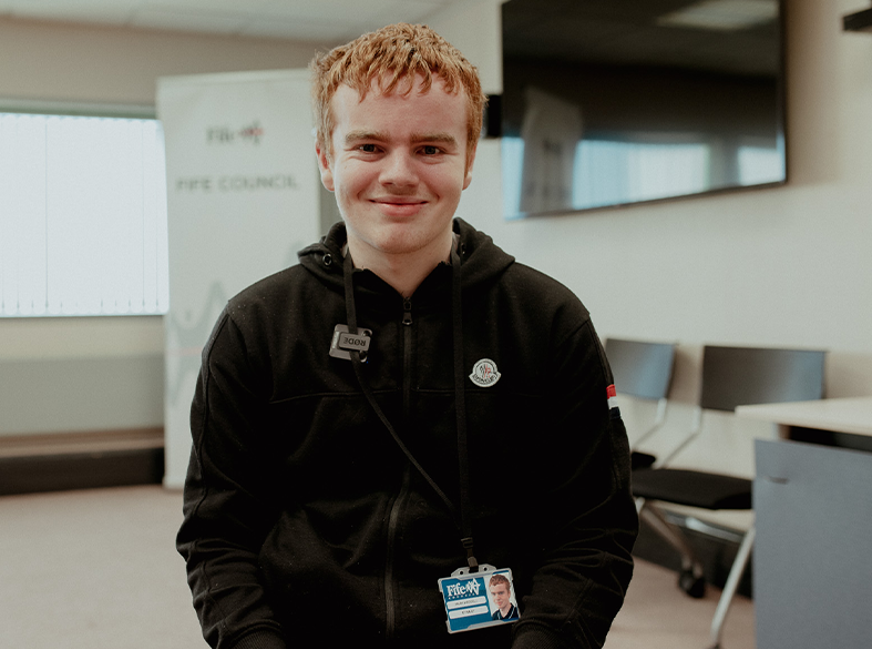 male student smiling at camera