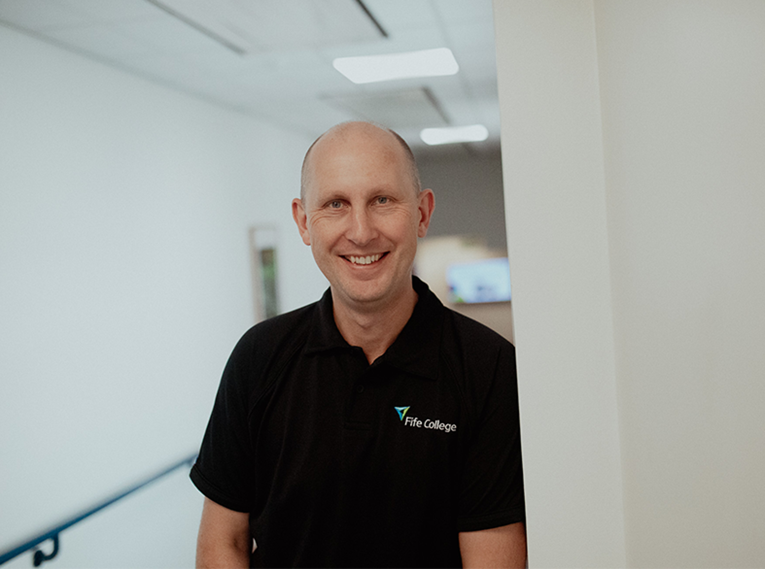 principal jim metcalfe smiling in hallway