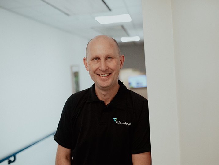 principal jim metcalfe smiling in hallway
