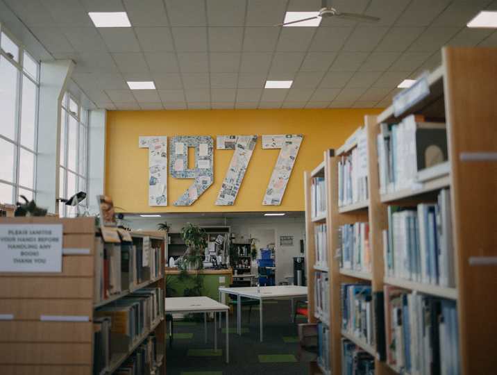 Dunfermline campus library with book shelves and artwork on wall