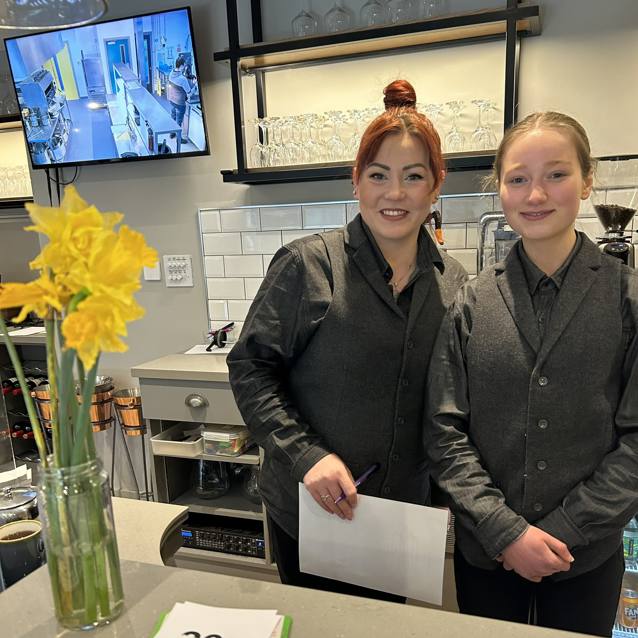 two students training in the academy restaurant
