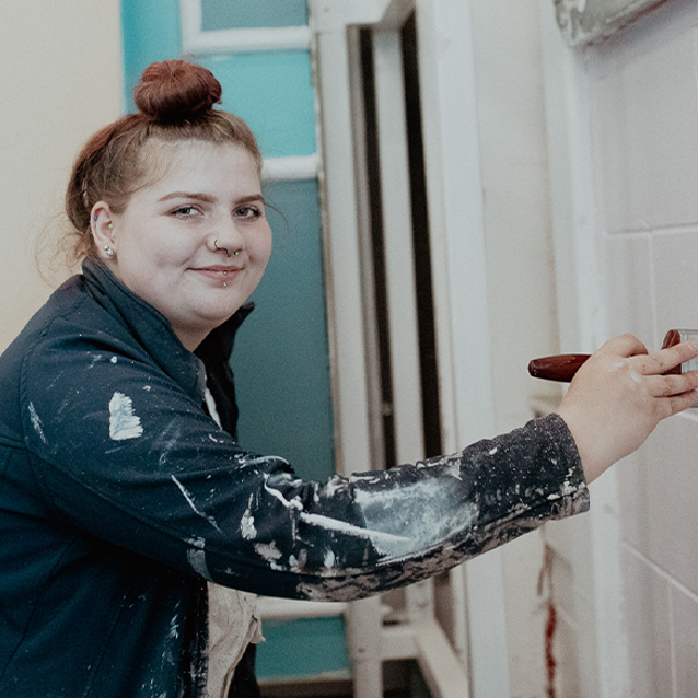 female built environment student painting