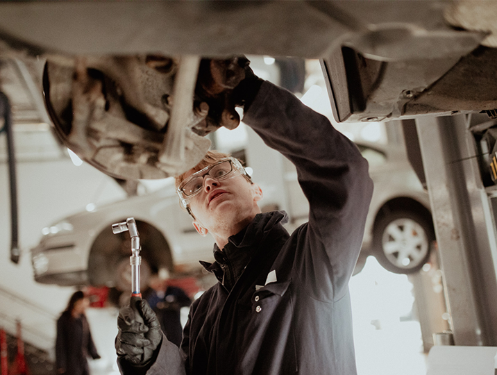 male automotive student working on car