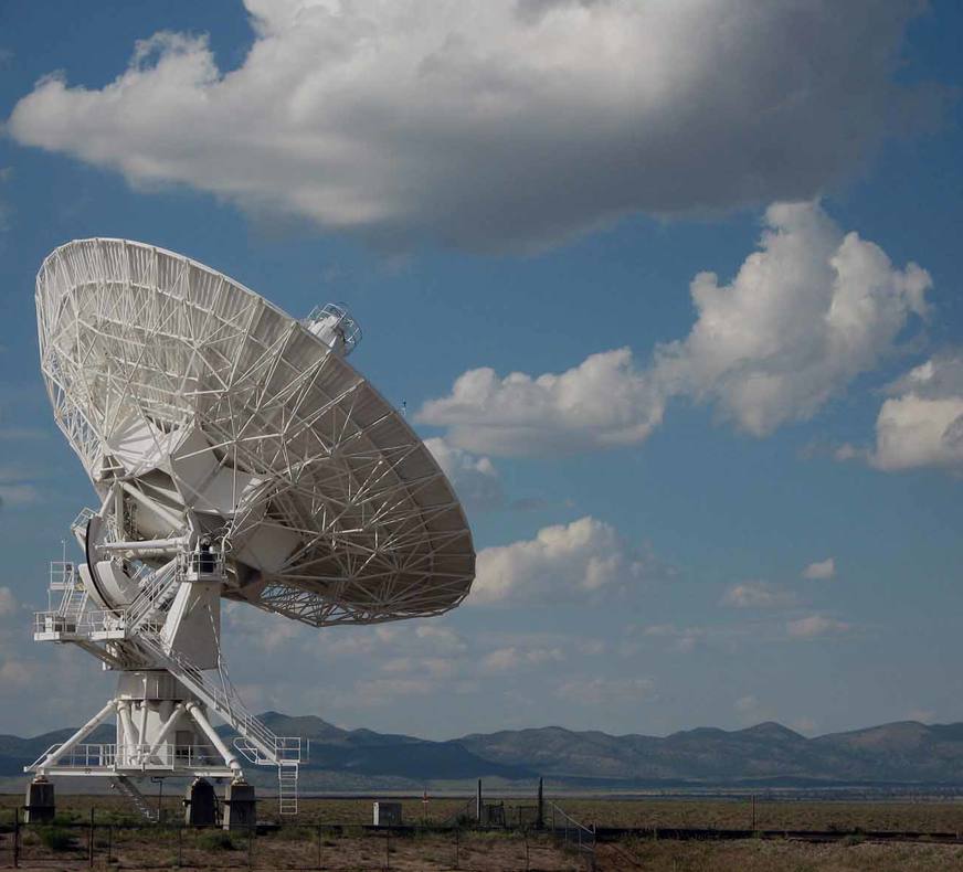 satelite on ground with sky in background